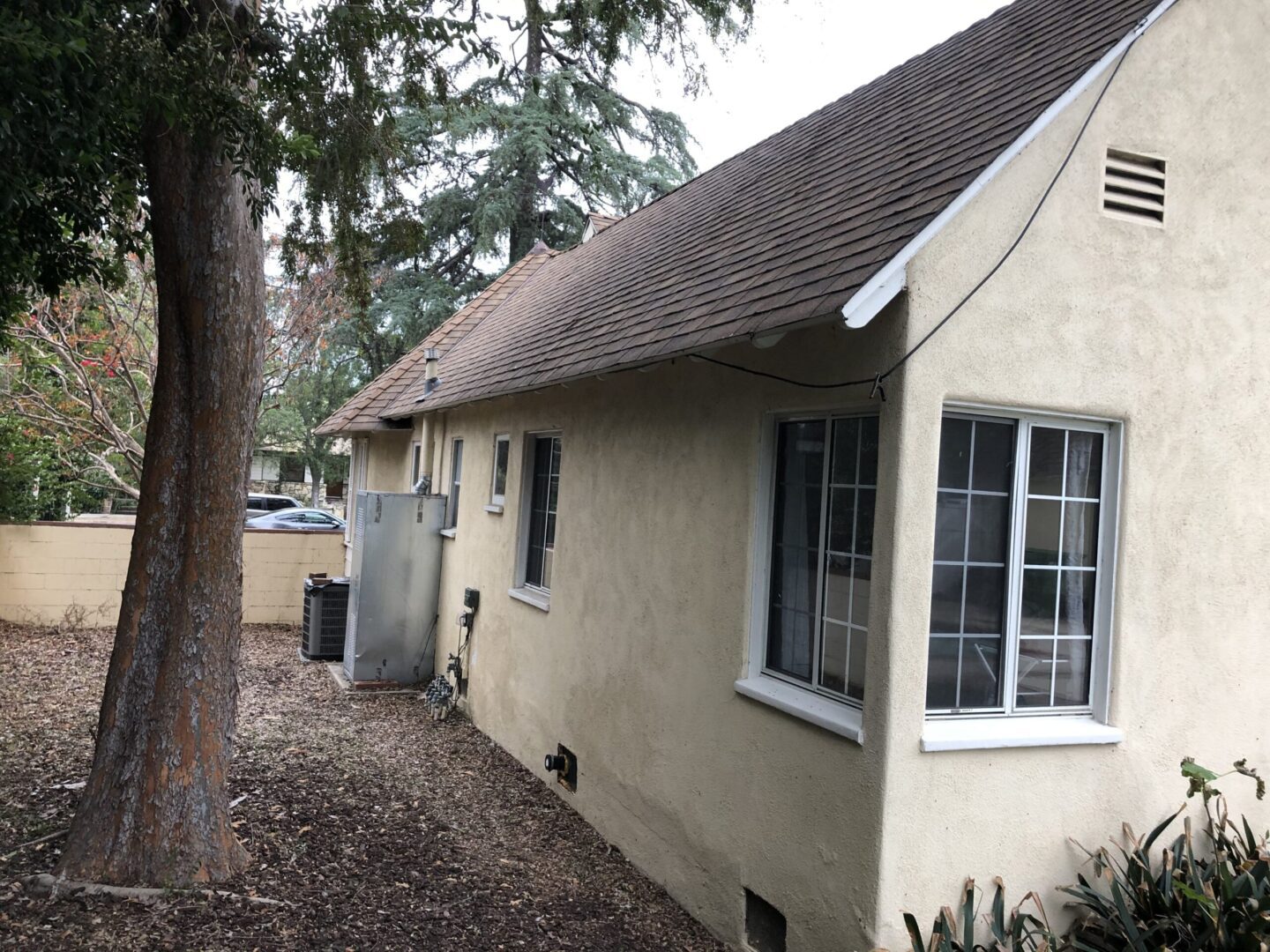 A house with a tree in the background