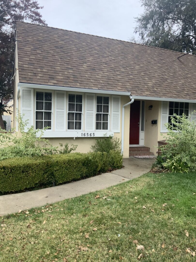 A house with a red door and white shutters.