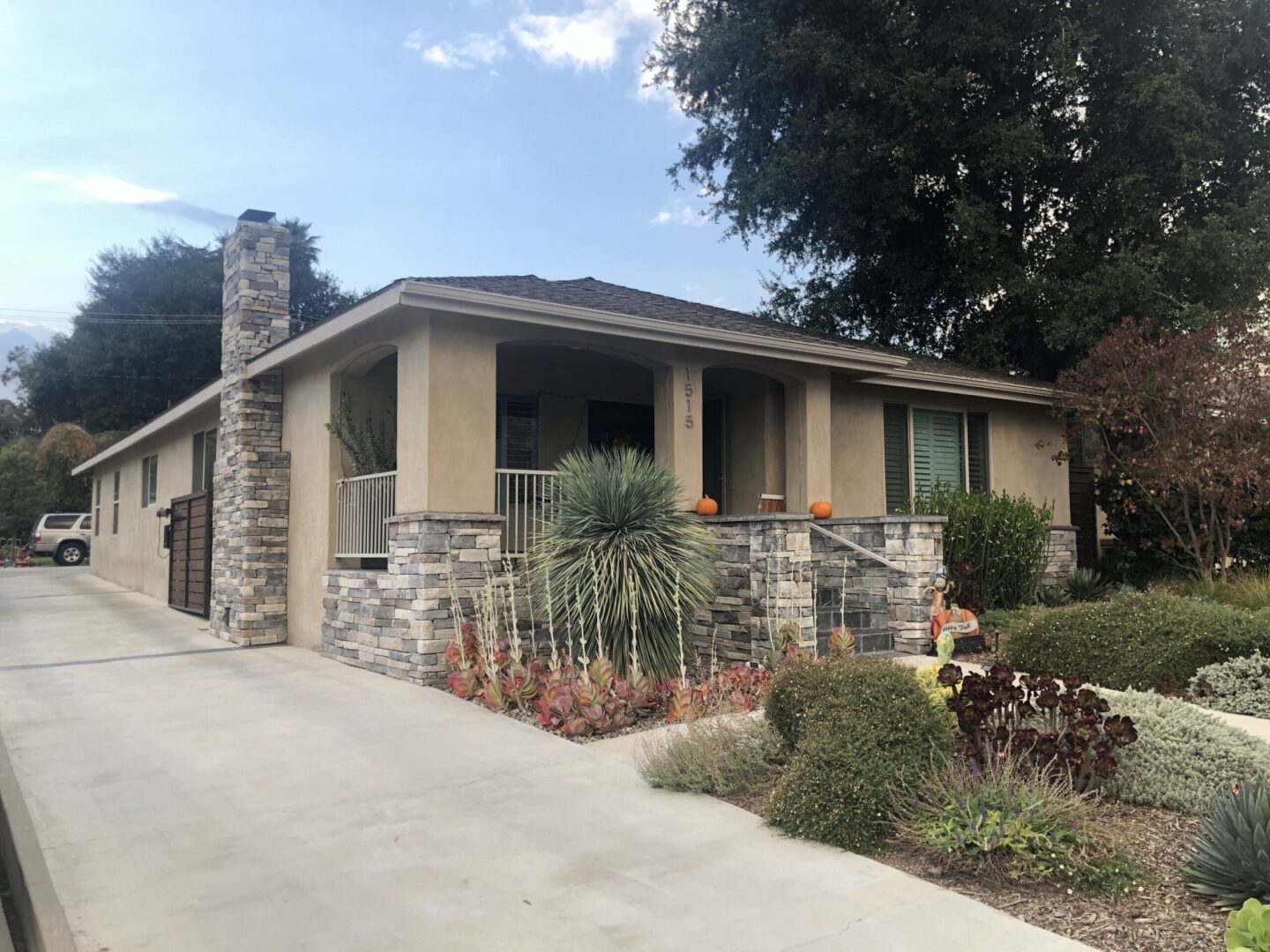 A house with stone walls and a large rock fireplace.