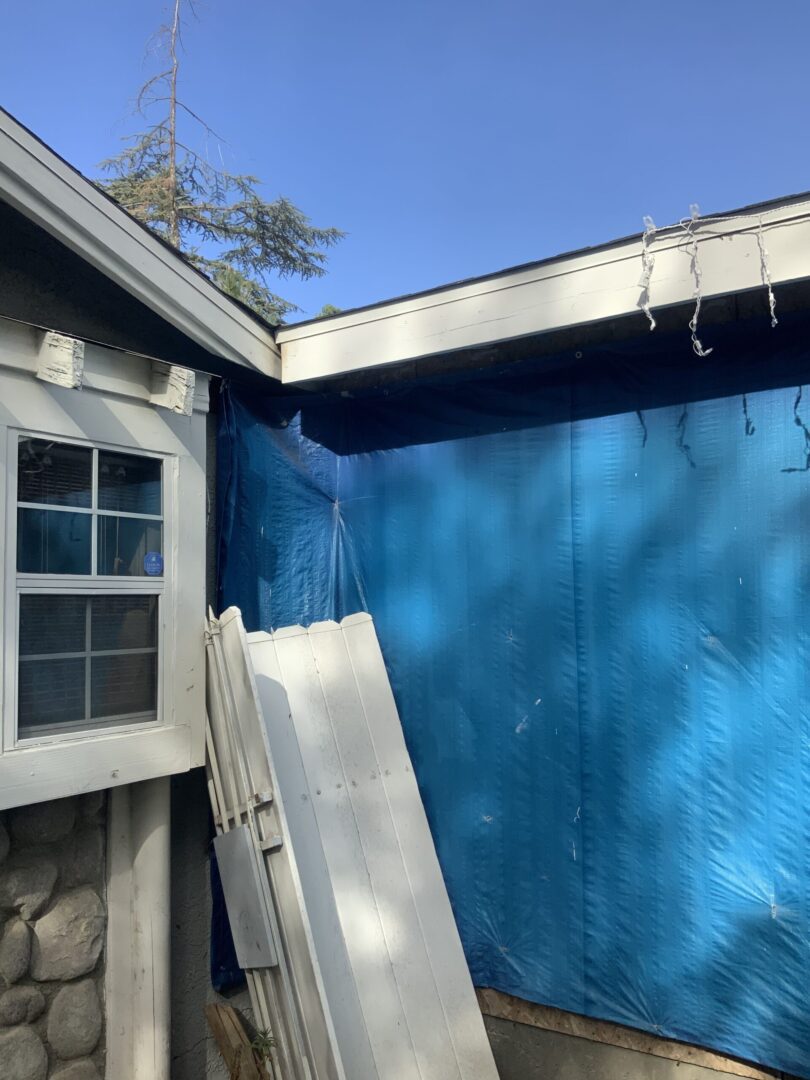 A house with blue walls and a white door.