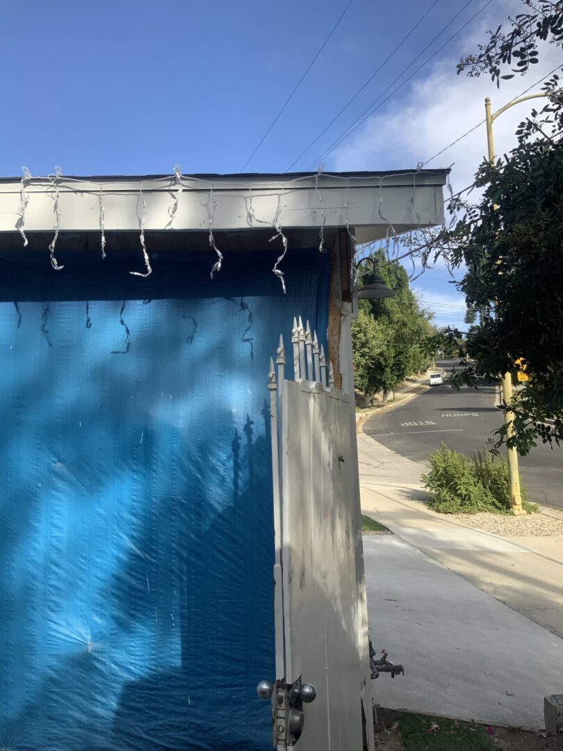 A blue garage door on the side of a building.