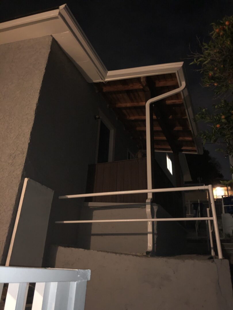 A night view of the outside stairs and railing.