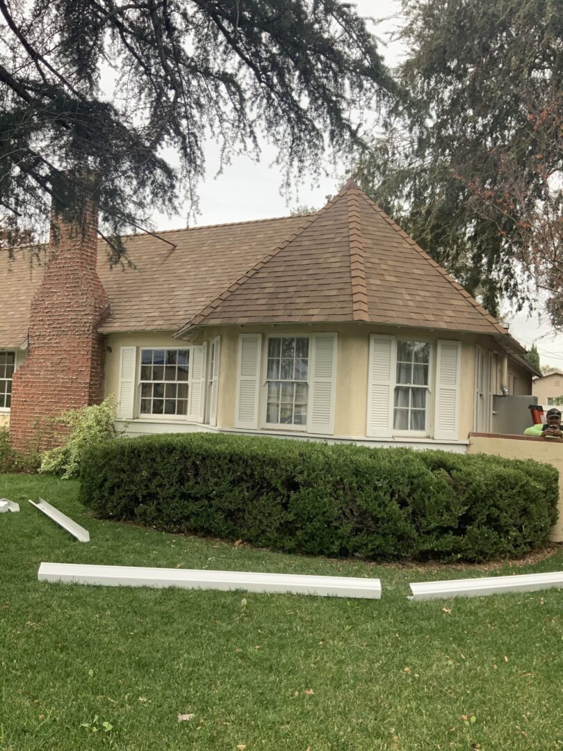 A house with a large yard and bushes