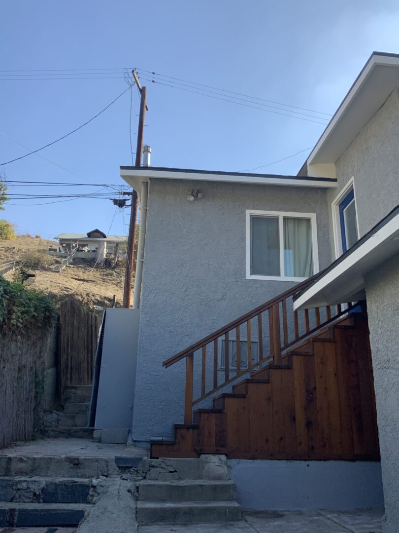 A house with stairs going up the side of it.