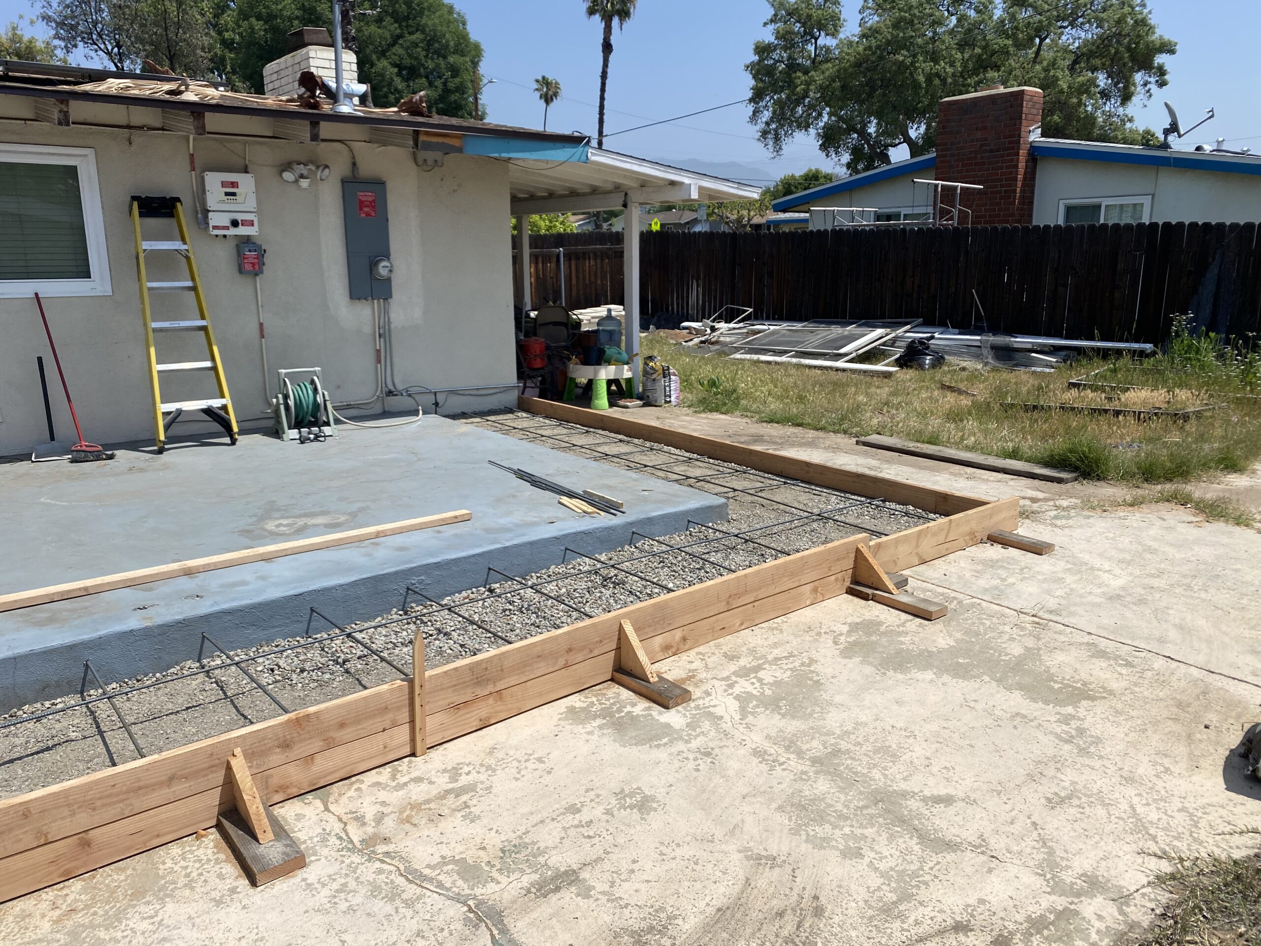 A concrete slab being poured for the foundation of a house.