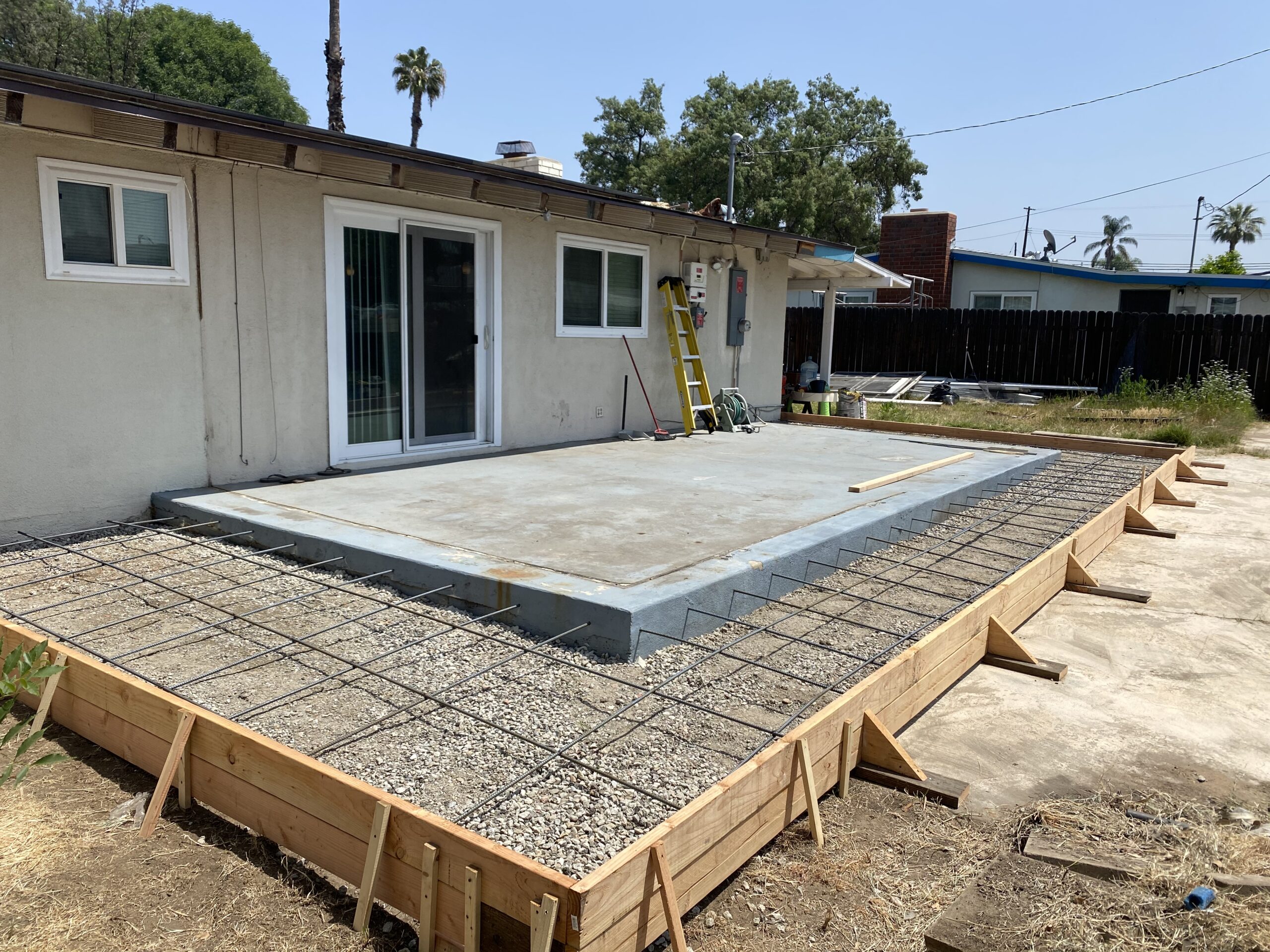 A concrete slab is being installed on the ground.