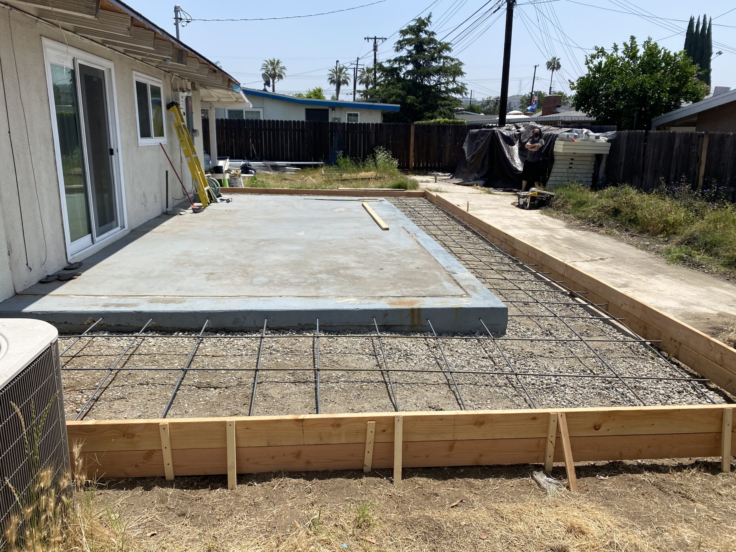 A concrete slab is being poured for the patio.