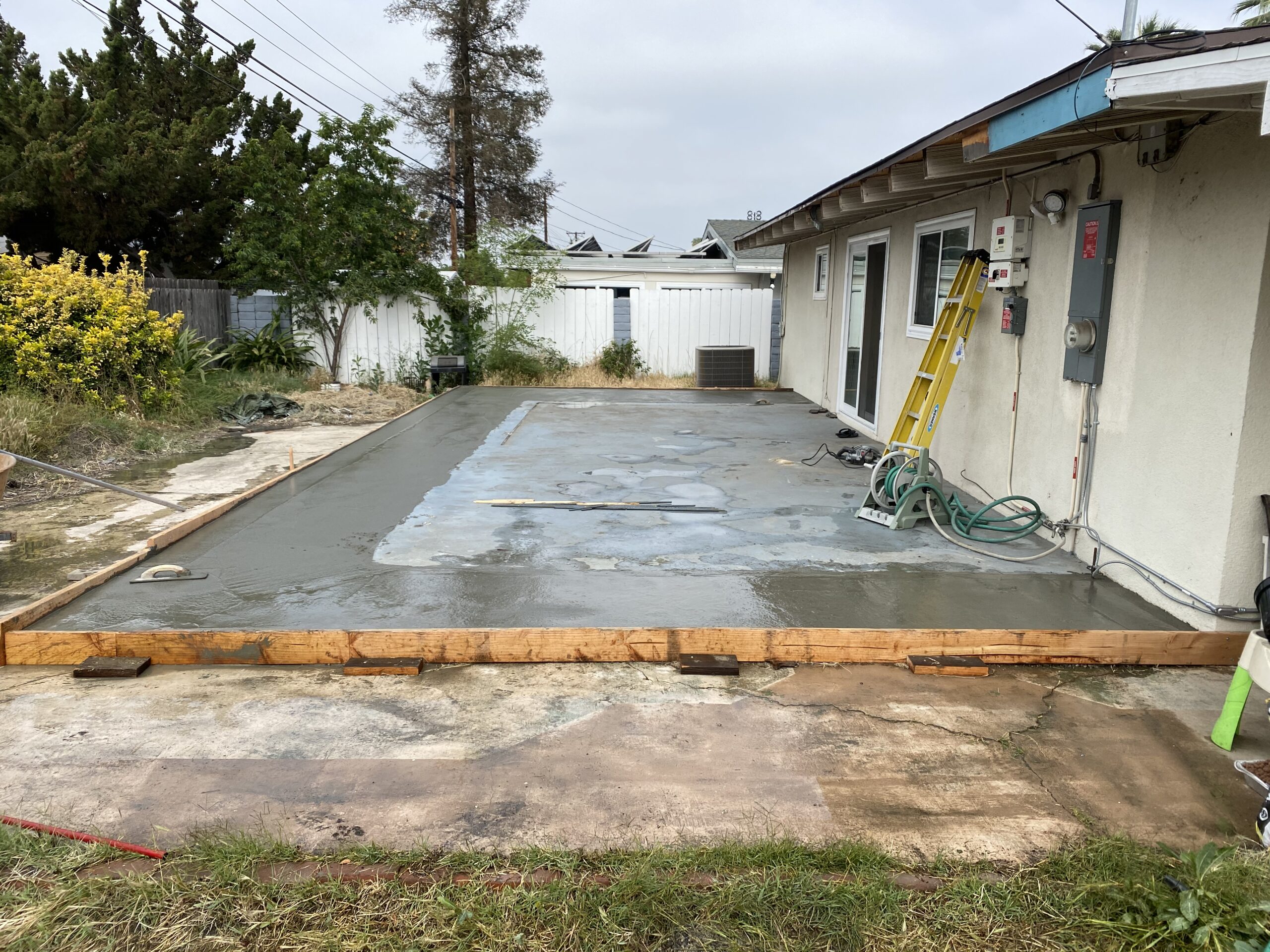 A concrete slab is being poured for the patio.