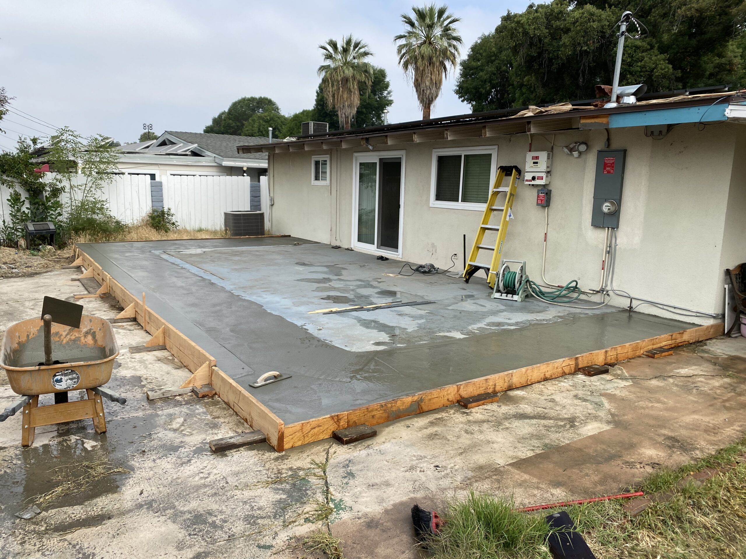 A concrete slab being poured for a house.