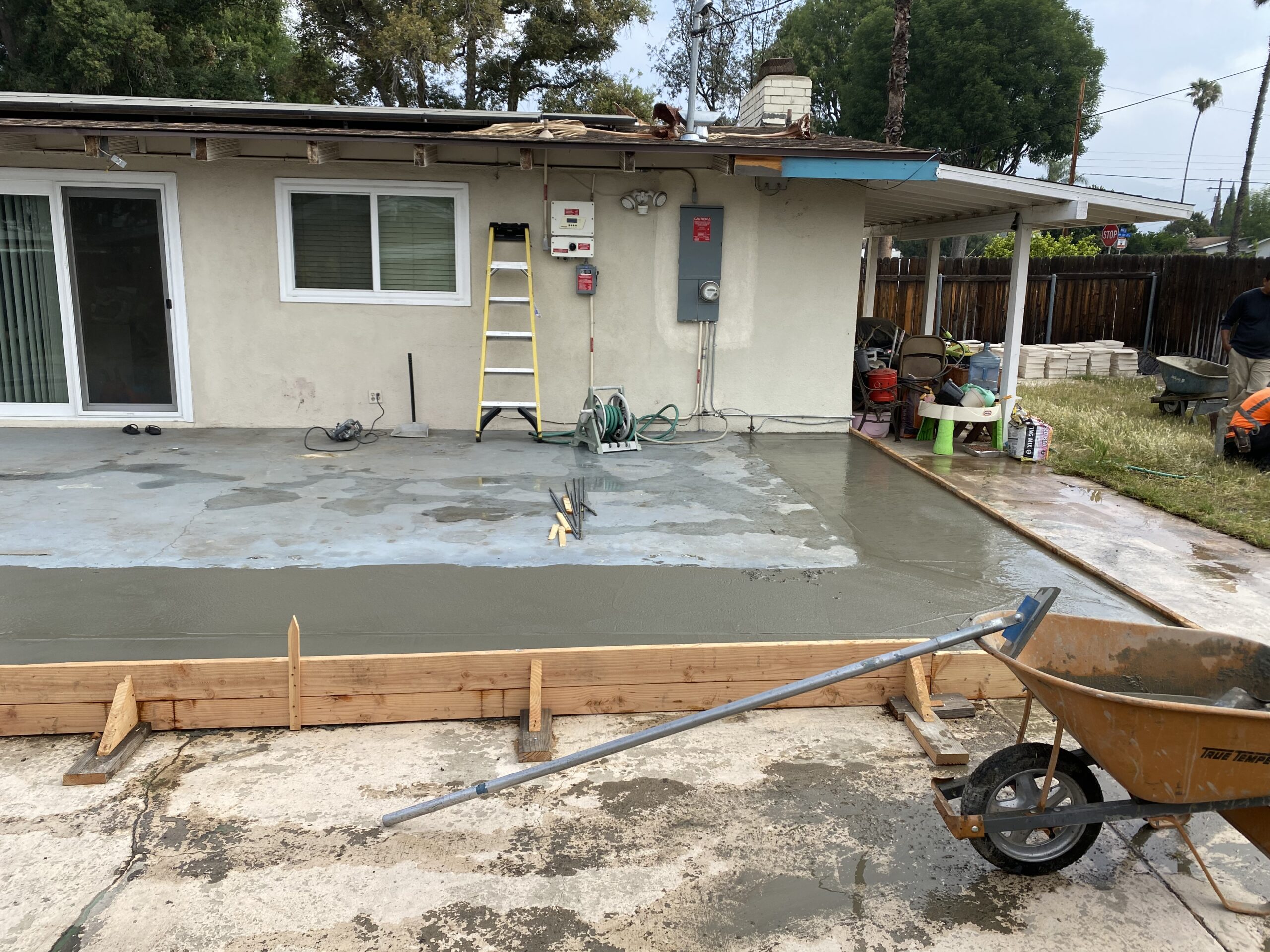 A concrete slab being poured for a house.