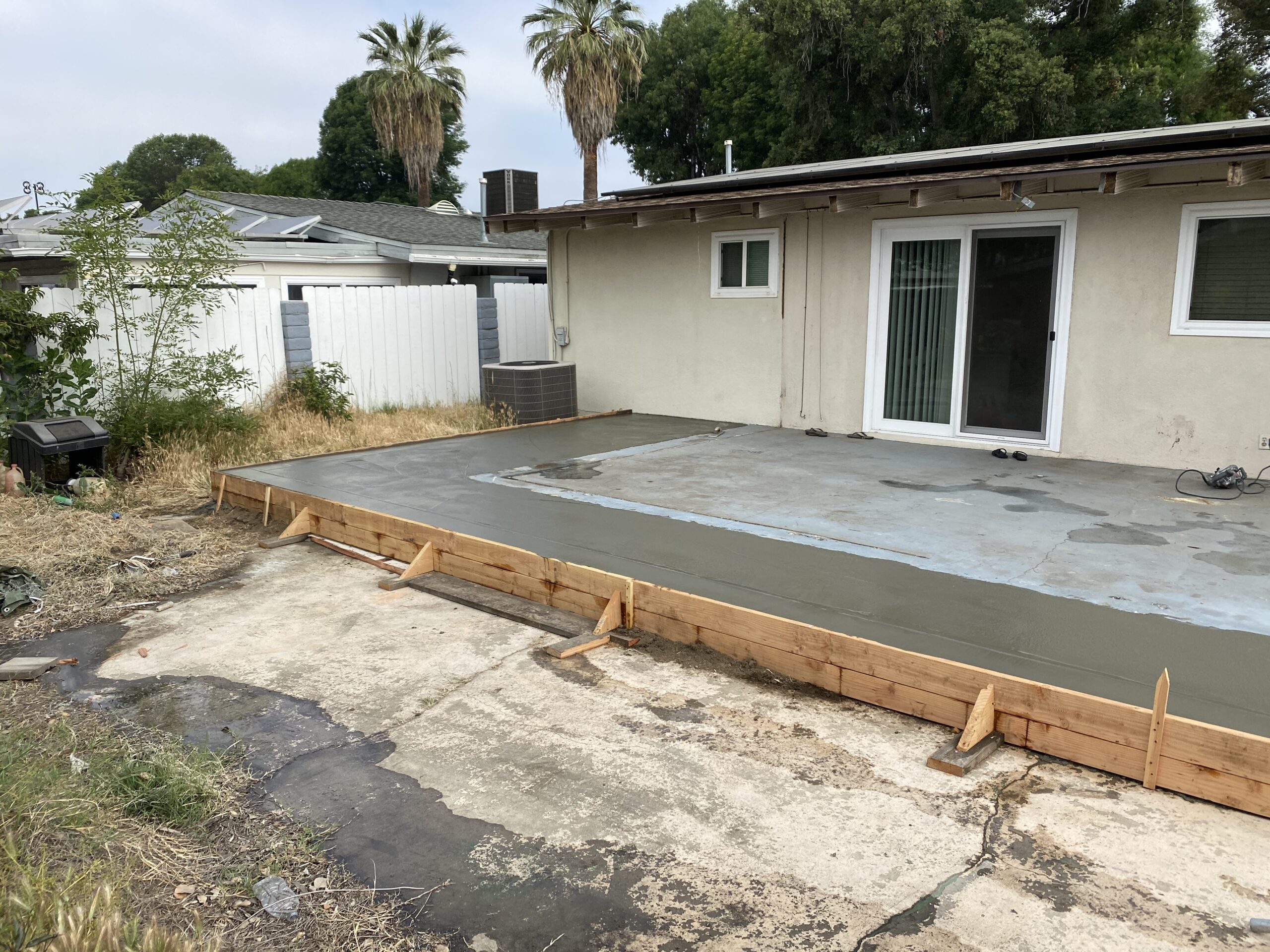 A concrete slab is being poured for the patio.