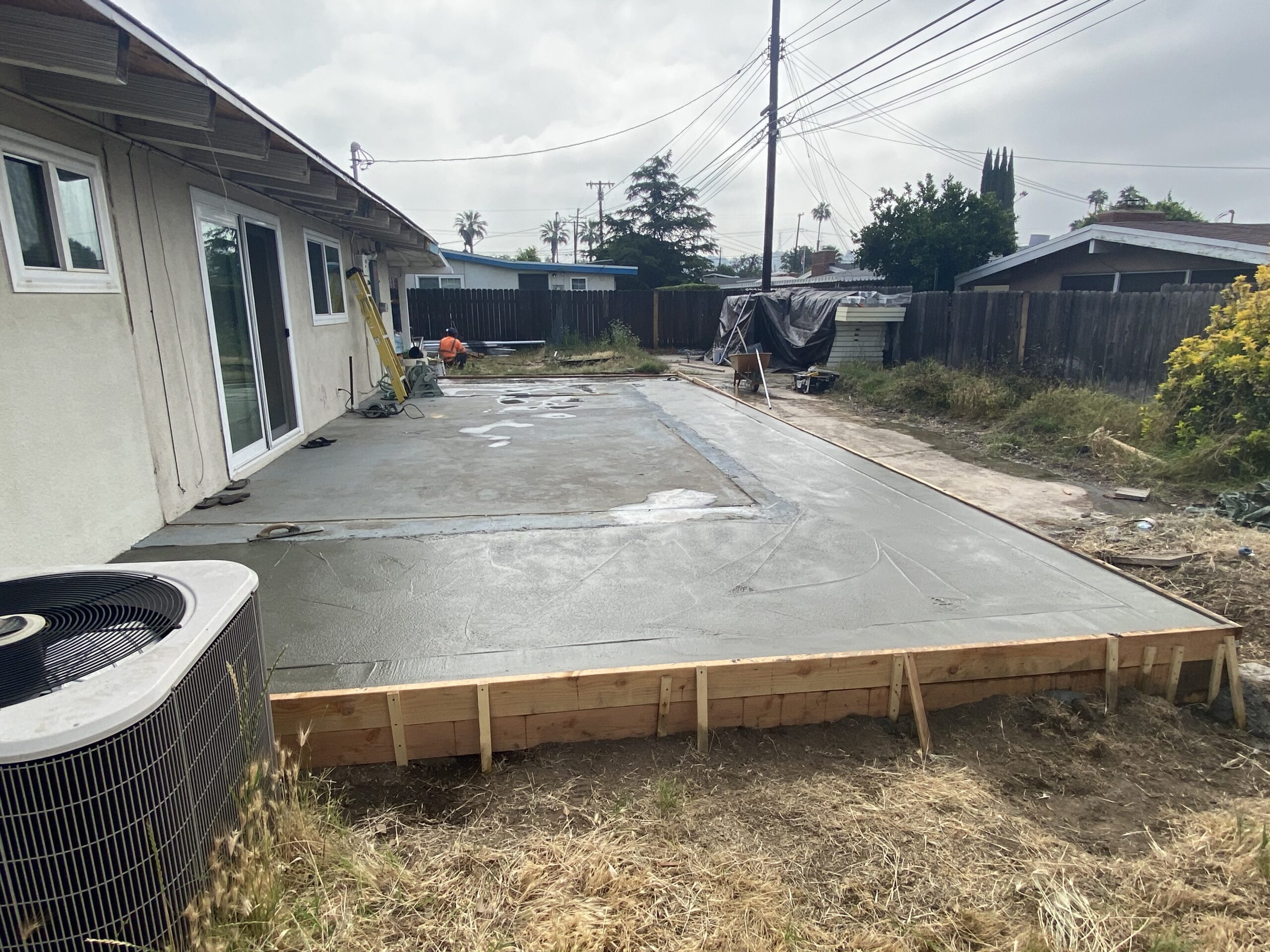 A concrete slab being poured for a house