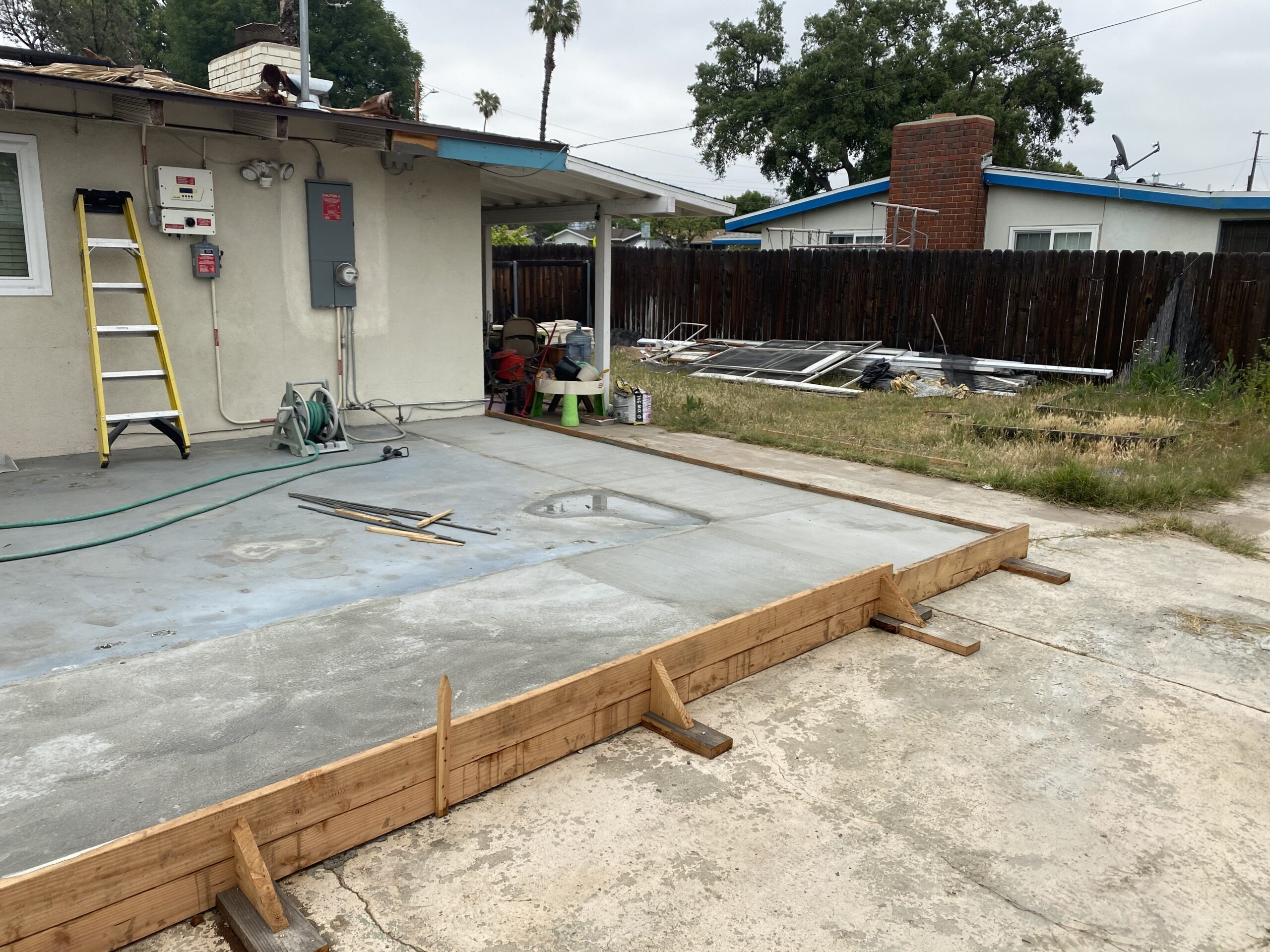 A concrete slab being poured for the foundation of a house.