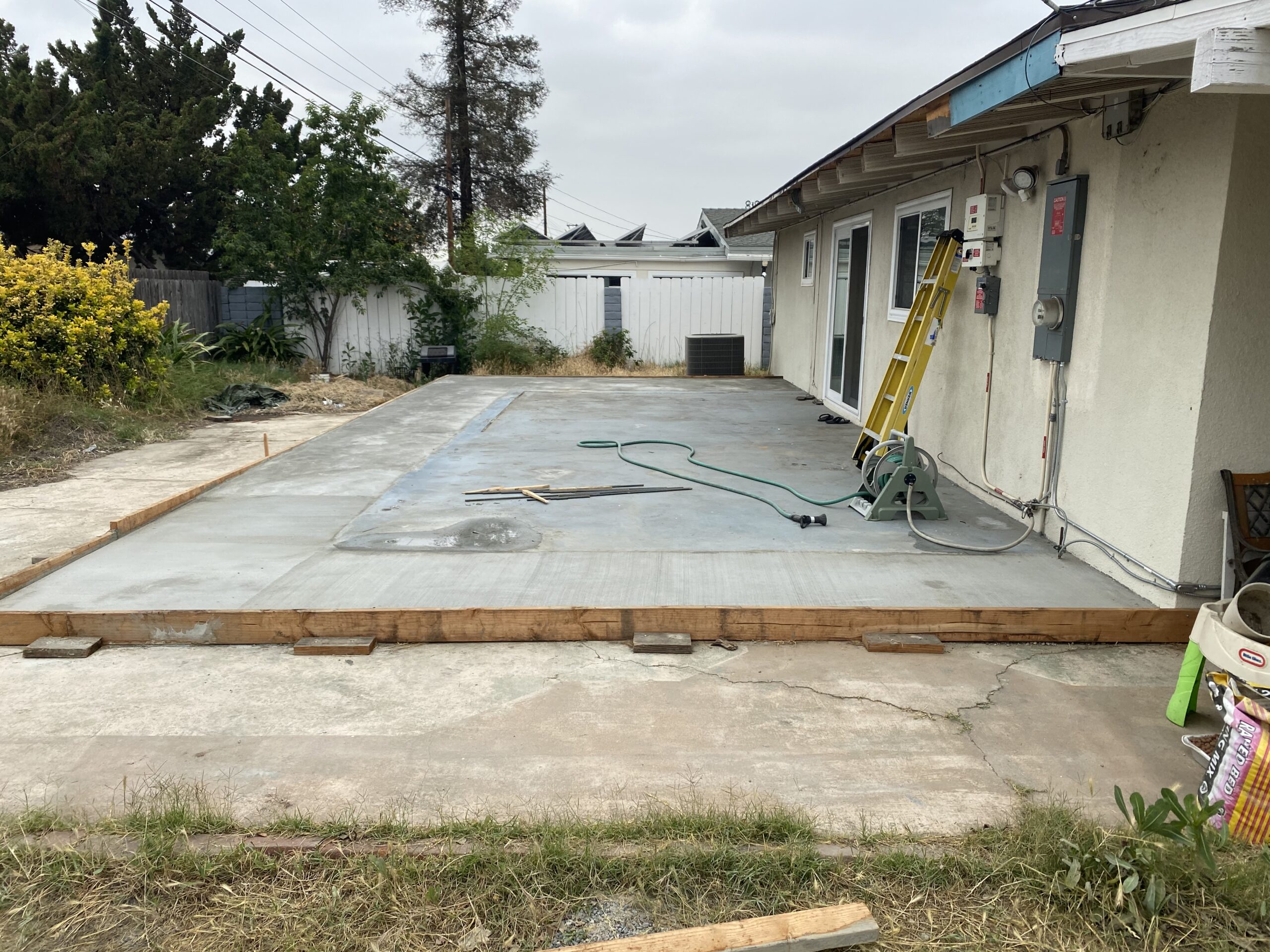 A concrete slab being poured for the back patio.