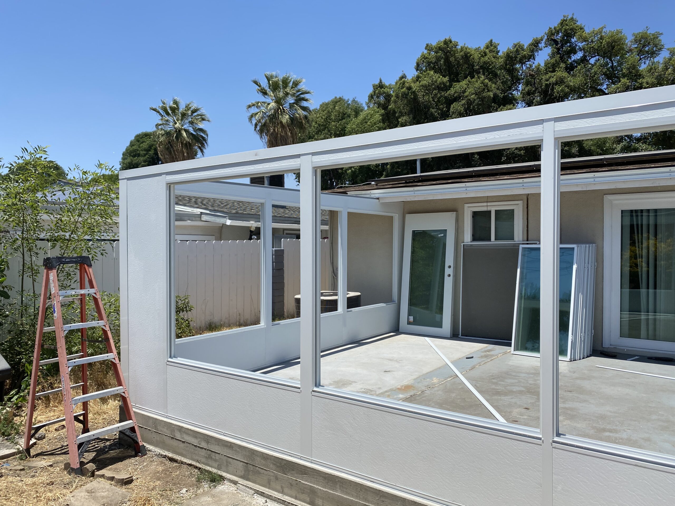 A house with a porch and windows being built