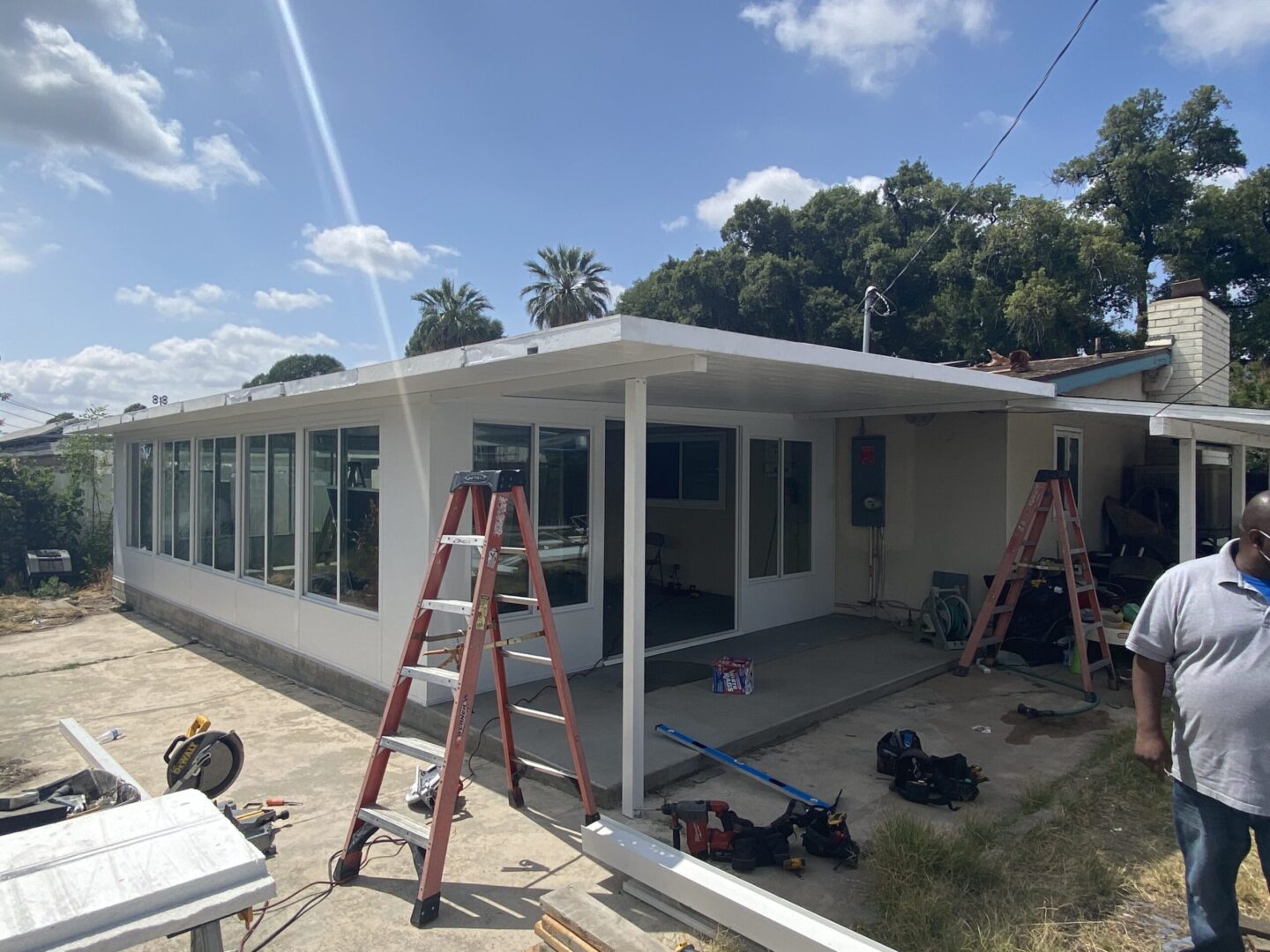 A house being remodeled with some people working on it