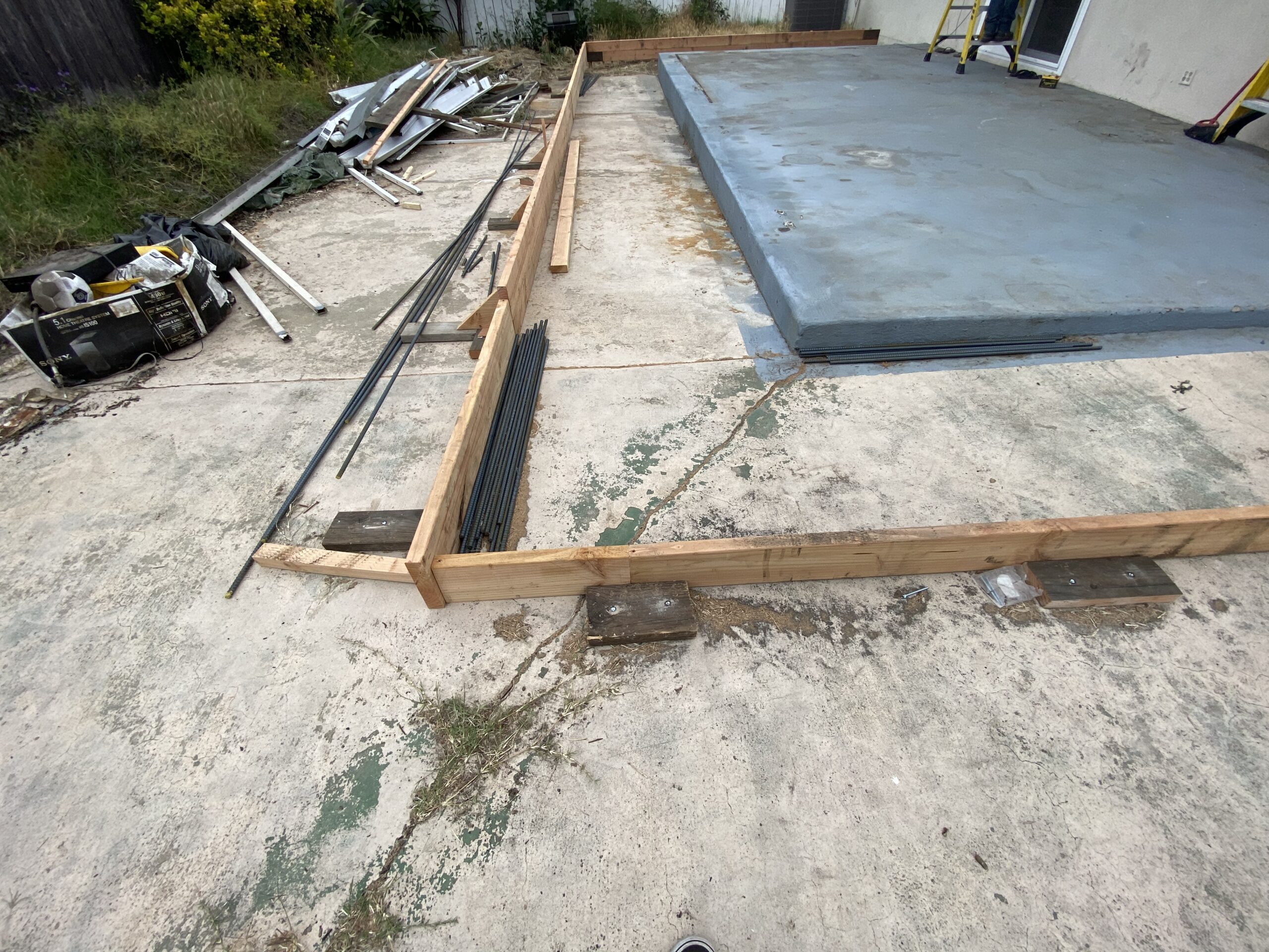 A concrete slab being built around the pool.