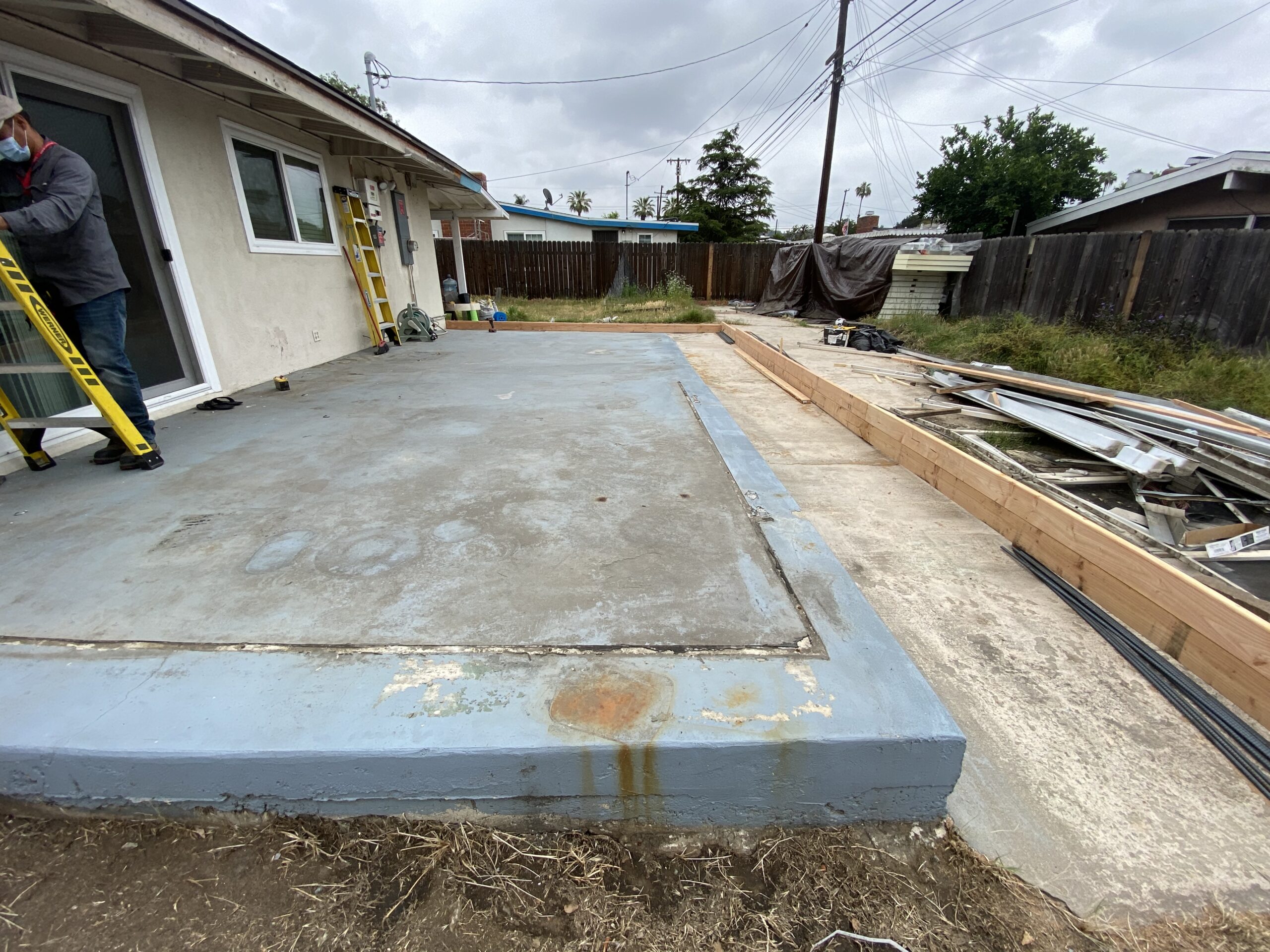 A concrete slab being poured for the foundation of a house.