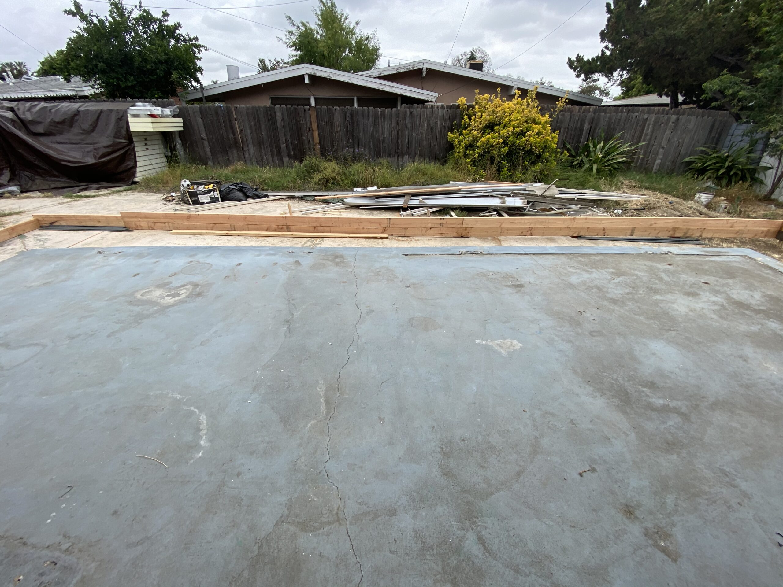 A view of a backyard from the street.