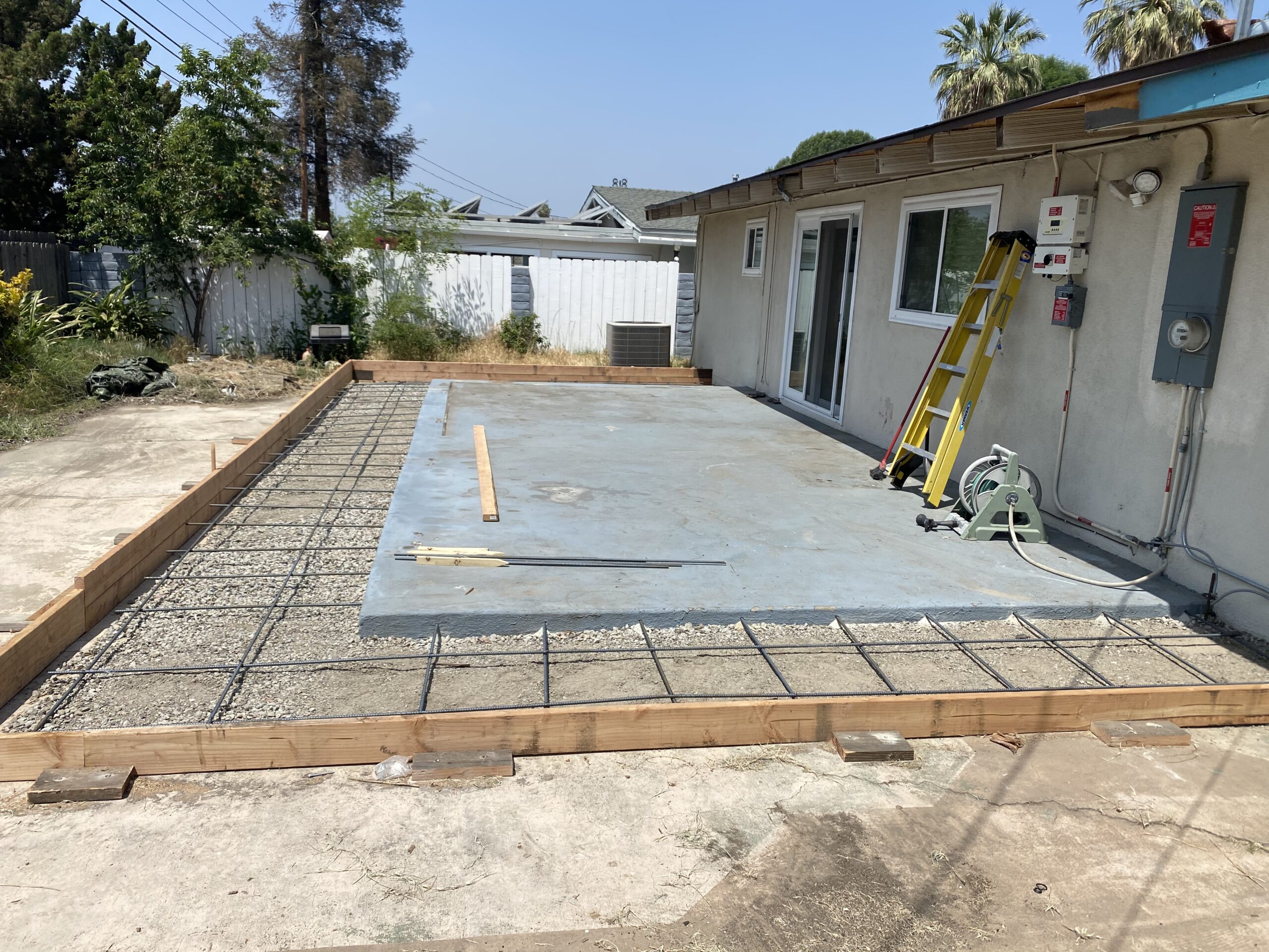 A concrete slab being installed in the middle of an outdoor area.